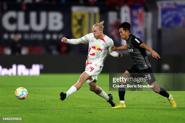 Xaver Schlager of RB Leipzig is challenged by Jeong Woo-Yeong of SC Freiburg during the Bundesliga match between RB Leipzig and Sport-Club Freiburg...