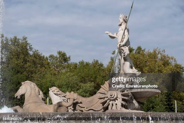 close up of neptune fountain on a sunny day in madrid. - fountain of neptune madrid stock-fotos und bilder