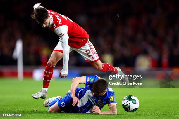 Fabio Vieira of Arsenal jumps over Billy Gilmour of Brighton & Hove Albion during the Carabao Cup Third Round match between Arsenal and Brighton &...