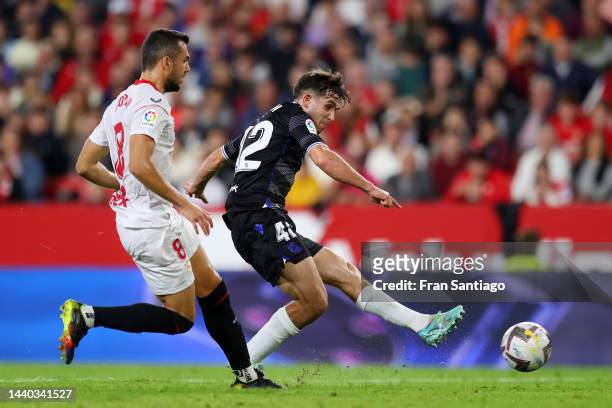 Aihen Munoz of Real Sociedad shoots while under pressure from Joan Jordan of Sevilla FC during the LaLiga Santander match between Sevilla FC and Real...