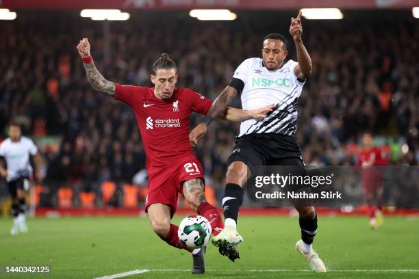 Kostas Tsimikas of Liverpool battles for possession with Nathaniel Mendez-Laing of Derby County during the Carabao Cup Third Round match between...