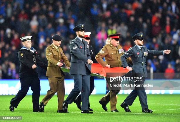 Members of the British Armed Services stand in the centre circle to show their support for remembrance day 2022 during the Cinch Scottish Premiership...