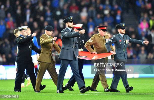 Members of the British Armed Services stand in the centre circle to show their support for remembrance day 2022 during the Cinch Scottish Premiership...