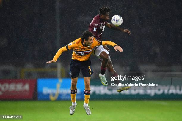 Wilfried Singo of Torino FC and Tommaso Augello of UC Sampdoria compete for a header during the Serie A match between Torino FC and UC Sampdoria at...
