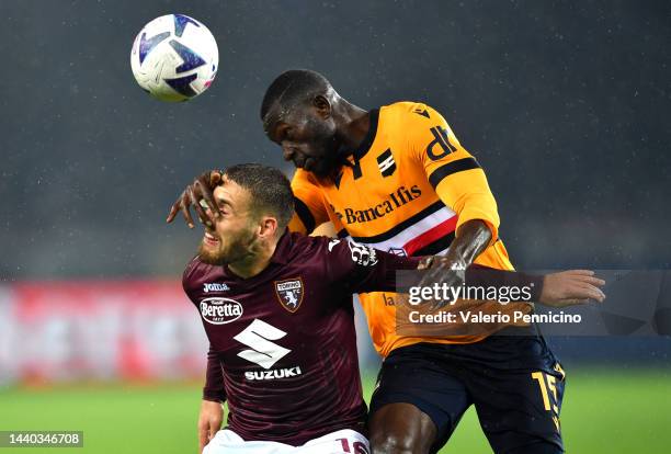 Nikola Vlasic of Torino FC is challenged by Omar Colley of UC Sampdoria during the Serie A match between Torino FC and UC Sampdoria at Stadio...