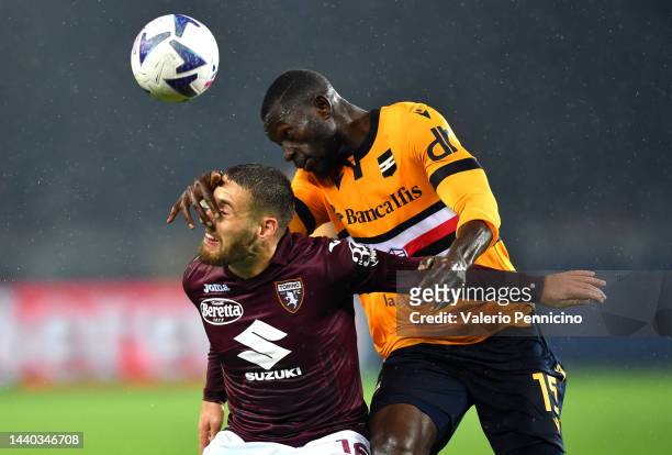 Nikola Vlasic of Torino FC is challenged by Omar Colley of UC Sampdoria during the Serie A match between Torino FC and UC Sampdoria at Stadio...