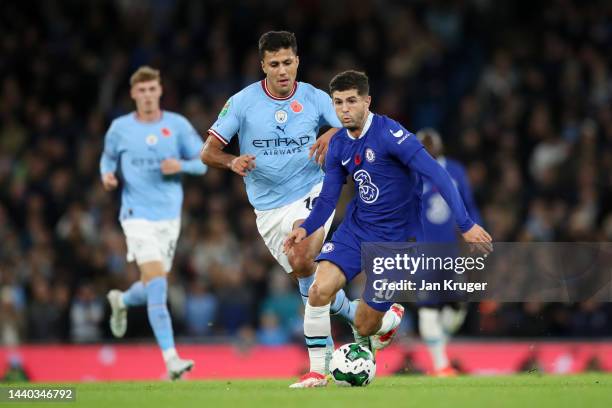 Christian Pulisic of Chelsea runs with the ball from Rodri of Manchester City during the Carabao Cup Third Round match between Manchester City and...