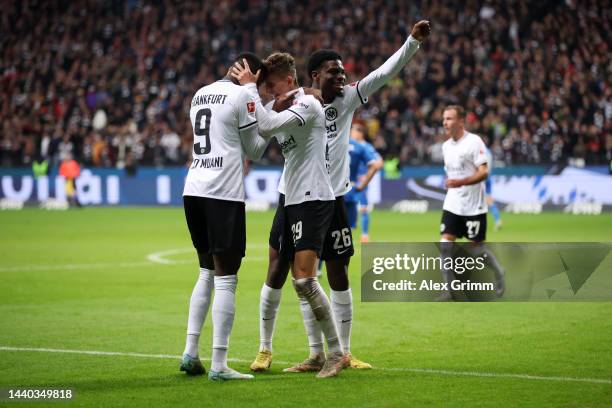 Jesper Lindstrom of Eintracht Frankfurt celebrates with team mate Randal Kolo Muani after scoring their sides fourth goal during the Bundesliga match...
