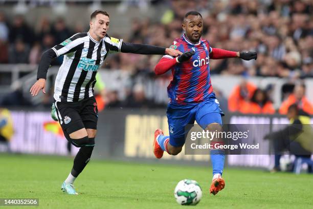 Jordan Ayew of Crystal Palace is challenged by Javi Manquillo of Newcastle United during the Carabao Cup Third Round match between Newcastle United...