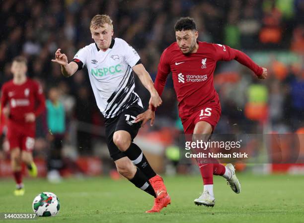 Louie Sibley of Derby County runs ahead of Alex Oxlade-Chamberlain of Liverpool during the Carabao Cup Third Round match between Liverpool and Derby...