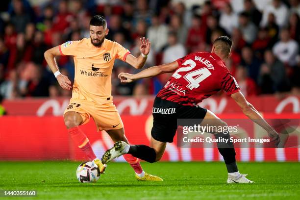 Martin Valjent of RCD Mallorca competes for the ball with Yannick Carrasco of Atletico de Madrid during the LaLiga Santander match between RCD...