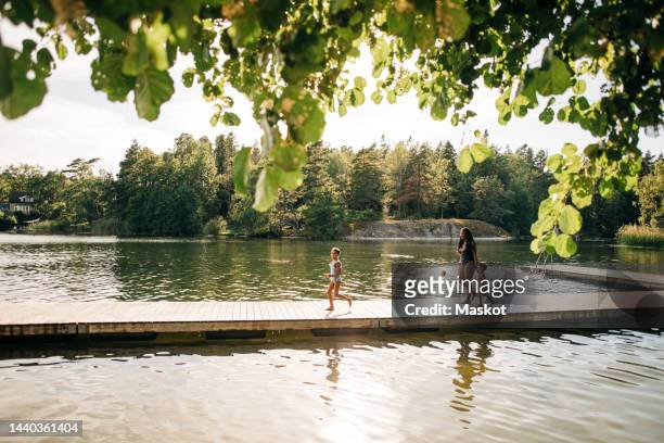 family enjoying at lake during vacation - stockholm summer stock-fotos und bilder