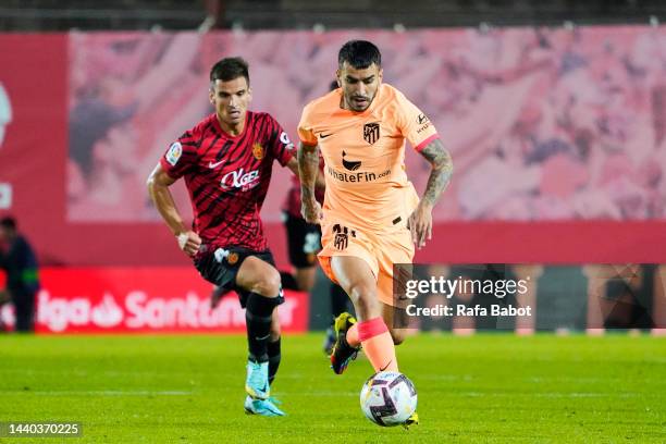 Angel Correa of Atletico de Madrid and Inigo Ruiz de Galarreta of RCD Mallorca compete for the ball during the LaLiga Santander match between RCD...