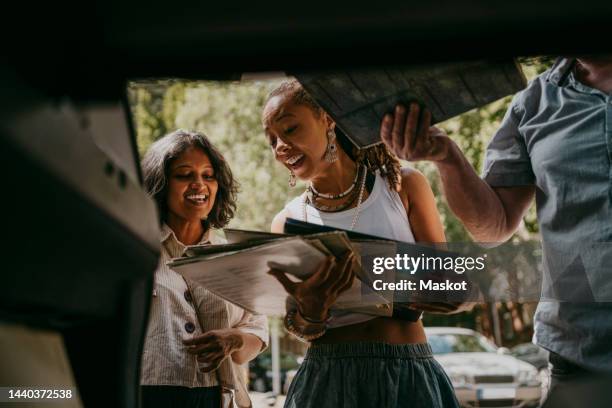 women discussing with each other holding vinyl records - flea market stock pictures, royalty-free photos & images