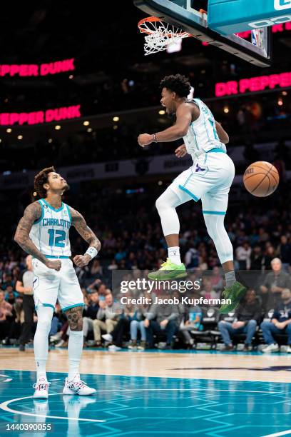 Dennis Smith Jr. #8 of the Charlotte Hornets celebrates his dunk with Kelly Oubre Jr. #12 in the first quarter against the Portland Trail Blazers at...