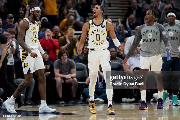 Oshae Brissett and Tyrese Haliburton of the Indiana Pacers reacts in the second quarter against the Denver Nuggets at Gainbridge Fieldhouse on...