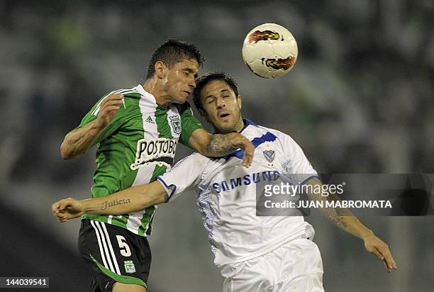 Argentina's Velez Sarsfield forward Juan Martinez vies for the ball with Colombia's Atletico Nacional defender Cristian Tula during their Copa...