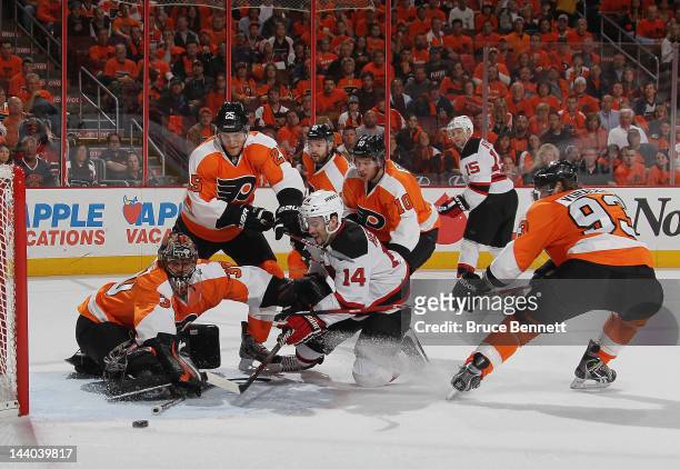 Adam Henrique of the New Jersey Devils is stopped by Ilya Bryzgalov and the Philadelphia Flyers in the first period in Game Five of the Eastern...