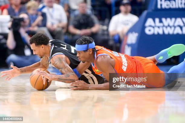 George Hill of the Milwaukee Bucks and Shai Gilgeous-Alexander of the Oklahoma City Thunder dive for a loose ball during the second quarter at Paycom...