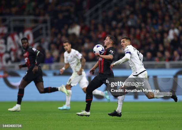 Ismael Bennacer of AC Milan contorls the ball on his chest as he is pursued by Mehdi Bourabia of Spezia Calcio as all players appear to run in snc...