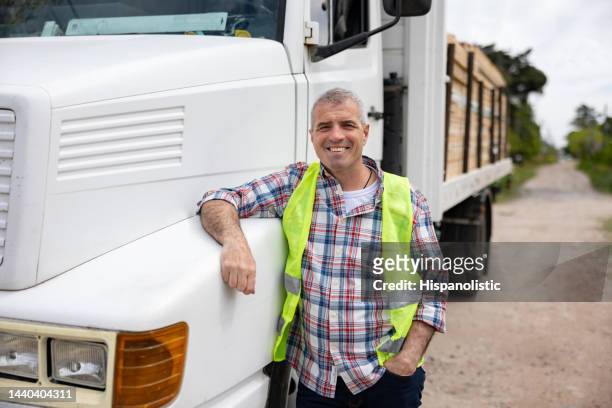 happy truck driver transporting construction materials - forestry stock pictures, royalty-free photos & images