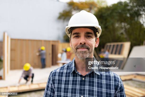 portrait of an architect working at a construction site - building contractor stock pictures, royalty-free photos & images