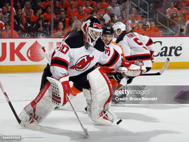 Martin Brodeur of the New Jersey Devils makes the second period save as Eric Wellwood of the Philadelphia Flyers looks for the rebound in Game Five...