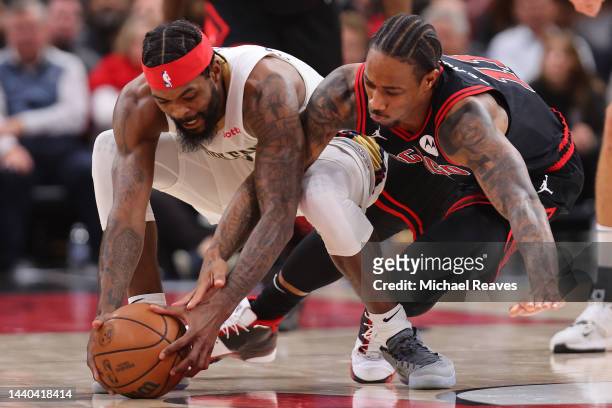 Naji Marshall of the New Orleans Pelicans and DeMar DeRozan of the Chicago Bulls dive for a loose ball during the second half at United Center on...