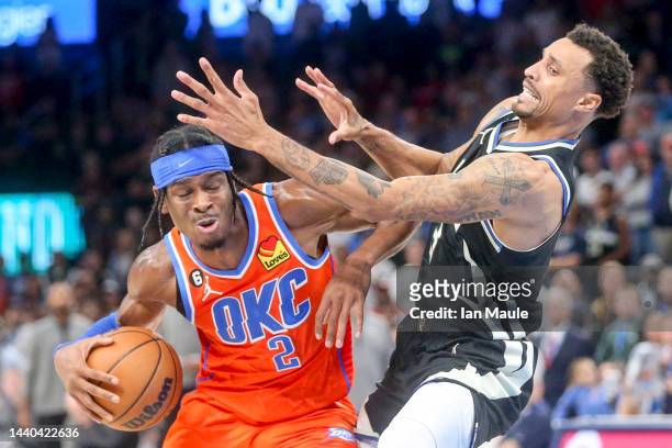 George Hill of the Milwaukee Bucks fouls Shai Gilgeous-Alexander of the Oklahoma City Thunder during the second overtime at Paycom Center on November...