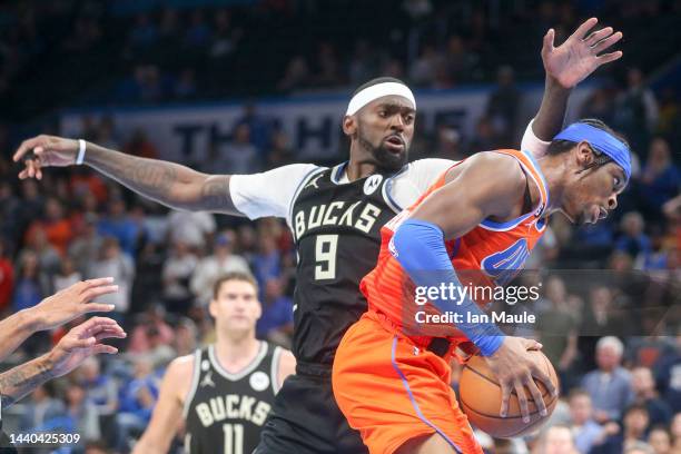 Shai Gilgeous-Alexander of the Oklahoma City Thunder grabs a rebound over Bobby Portis of the Milwaukee Bucks during the fourth quarter at Paycom...