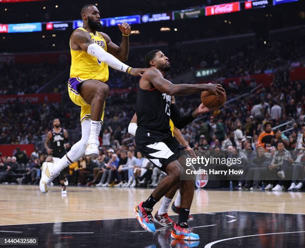 Paul George of the LA Clippers is fouled by LeBron James of the Los Angeles Lakers as he attempts to score on a layup during a 114-101 Clippers win...