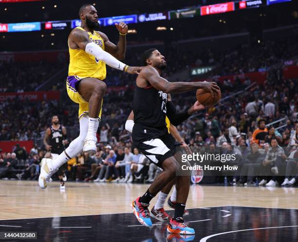 Paul George of the LA Clippers is fouled by LeBron James of the Los Angeles Lakers as he attempts to score on a layup during a 114-101 Clippers win...