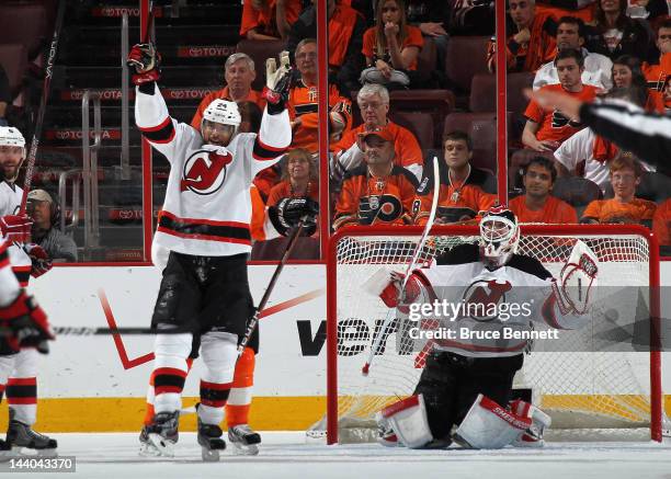 Bryce Salvador and Martin Brodeur of the New Jersey Devils celebrate their 3-1 victory over the Philadelphia Flyers in Game Five of the Eastern...