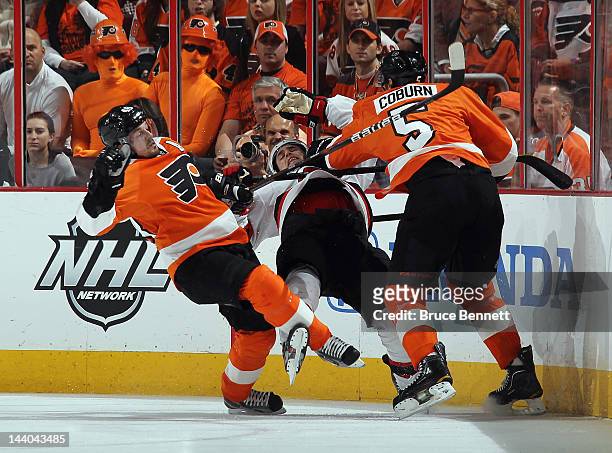 Danny Briere and Braydon Coburn of the Philadelphia Flyers combine to hit Zach Parise of the New Jersey Devils in Game Five of the Eastern Conference...