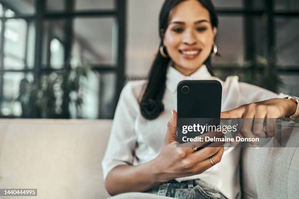 smartphone, social media and business woman with networking online notification, chat mobile app and website information on office sofa. young woman using phone for career or internship job search - subscription stockfoto's en -beelden