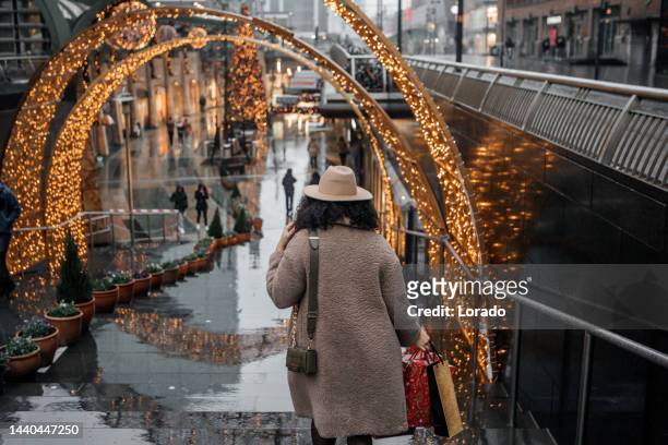 a mixed race woman at winter xmas shopping in rotterdam - netherlands christmas stock pictures, royalty-free photos & images