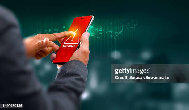 cybercriminals or anonymous hackers use malware on mobile phones to hack personal and business passwords online. - spyware stock pictures, royalty-free photos & images