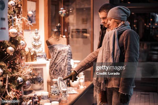 a foreign traveller couple on a date at winter xmas shopping in delft - delft stock pictures, royalty-free photos & images