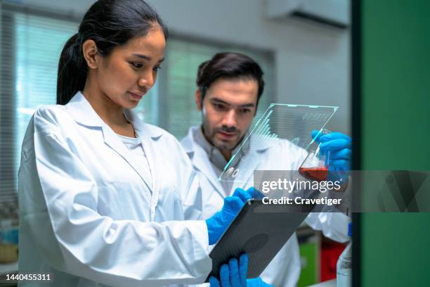 the diversity of scientists has a discussing their research on aquatic toxicity testing samples compare with data in digitization display in an environmental laboratory. they find the method for reduce toxic in environment. - nuclear waste management stock pictures, royalty-free photos & images