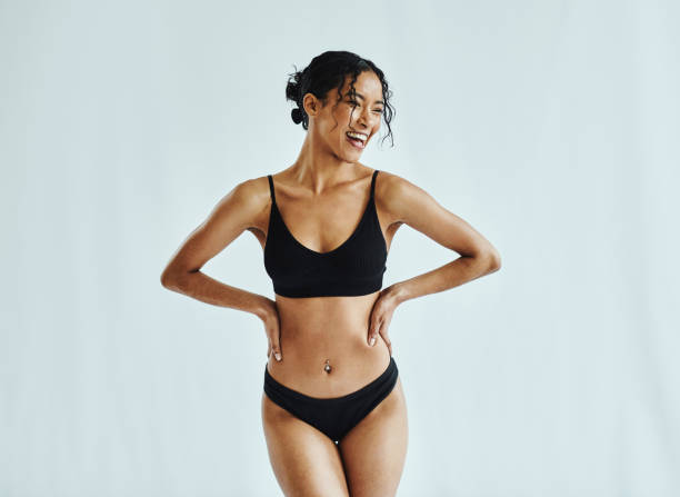 happy, woman and lingerie in a studio for wellness, beauty and weight loss against a white background mockup. health, black woman and underwear model posing, laughing and feeling confident mock up - mulher bonita imagens e fotografias de stock
