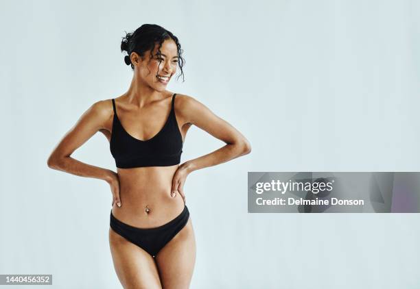 body positivity, young woman in bikini with smile, being confident and happy with white studio background. female, pride and care with healthy natural beauty, skincare or happiness with skin - model smile stockfoto's en -beelden