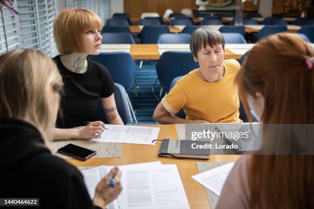 adult students learning together at a refugee educational centre - student visa stockfoto's en -beelden