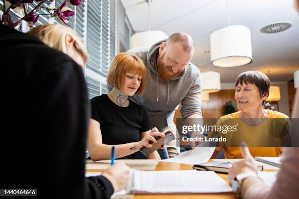 a community care giver volunteering at a refugee learning centre - student visa stockfoto's en -beelden