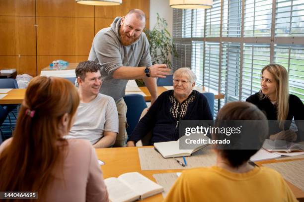 a community care giver volunteering at a refugee learning centre - organisation for migration stock pictures, royalty-free photos & images