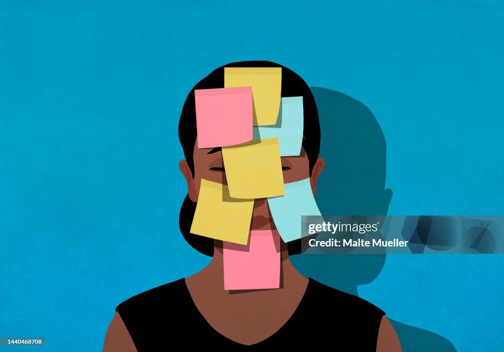 Adhesive notes covering face of exhausted woman
