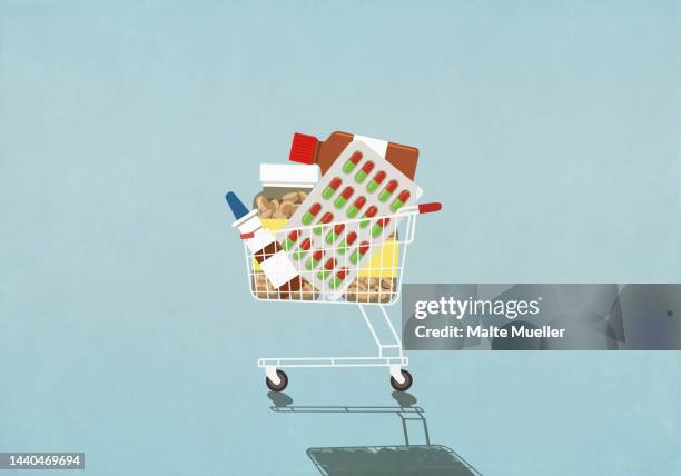 variety of medication in shopping cart on blue background - medical condition stock illustrations