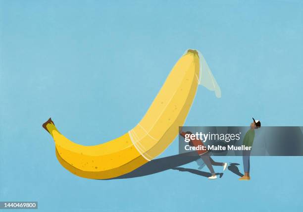 couple placing condom on large banana - contraceptive stock illustrations