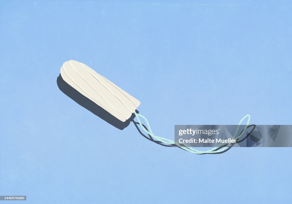 Tampon with string on blue background