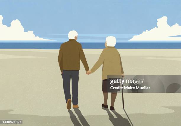 affectionate senior couple holding hands, walking on sunny ocean beach - retirement stock illustrations