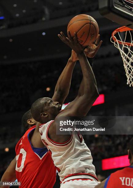 Loul Deng of the Chicago Bulls puts up a shot against Lavoy Allen of the Philadelphia 76ers on his way to a game-high 24 points in Game Five of the...